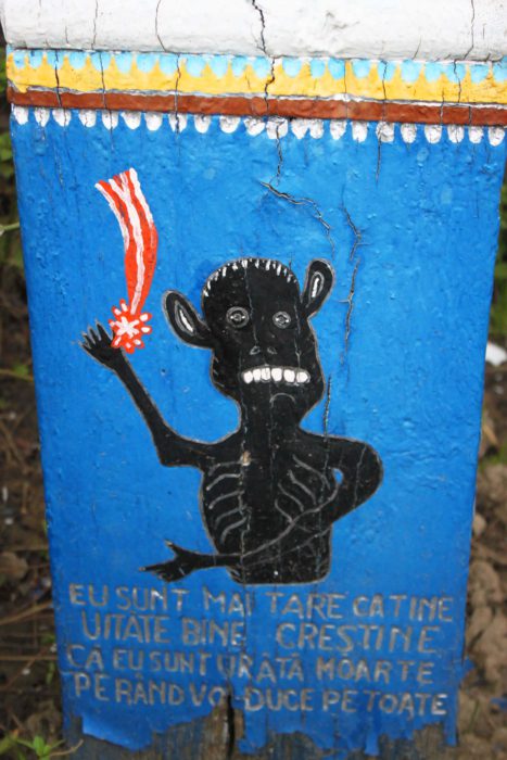 Black satan on the cemetery.