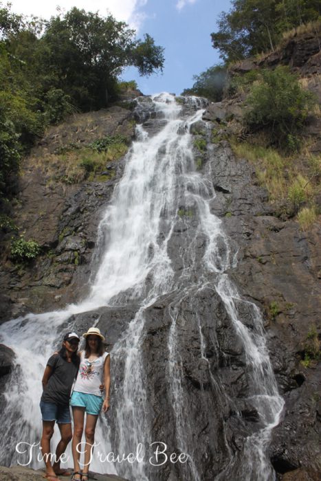 Waterfall in Khao Yai with natural fish spa. Two girls having selfie in front of the waterfall in the biggest National park in Thailand.