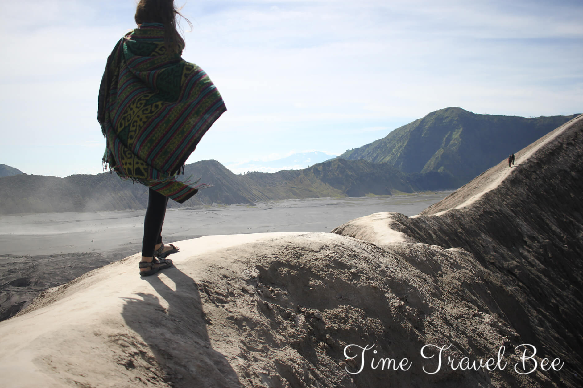 Girl walking on the edge of the crater bromo volcano Indonesia.