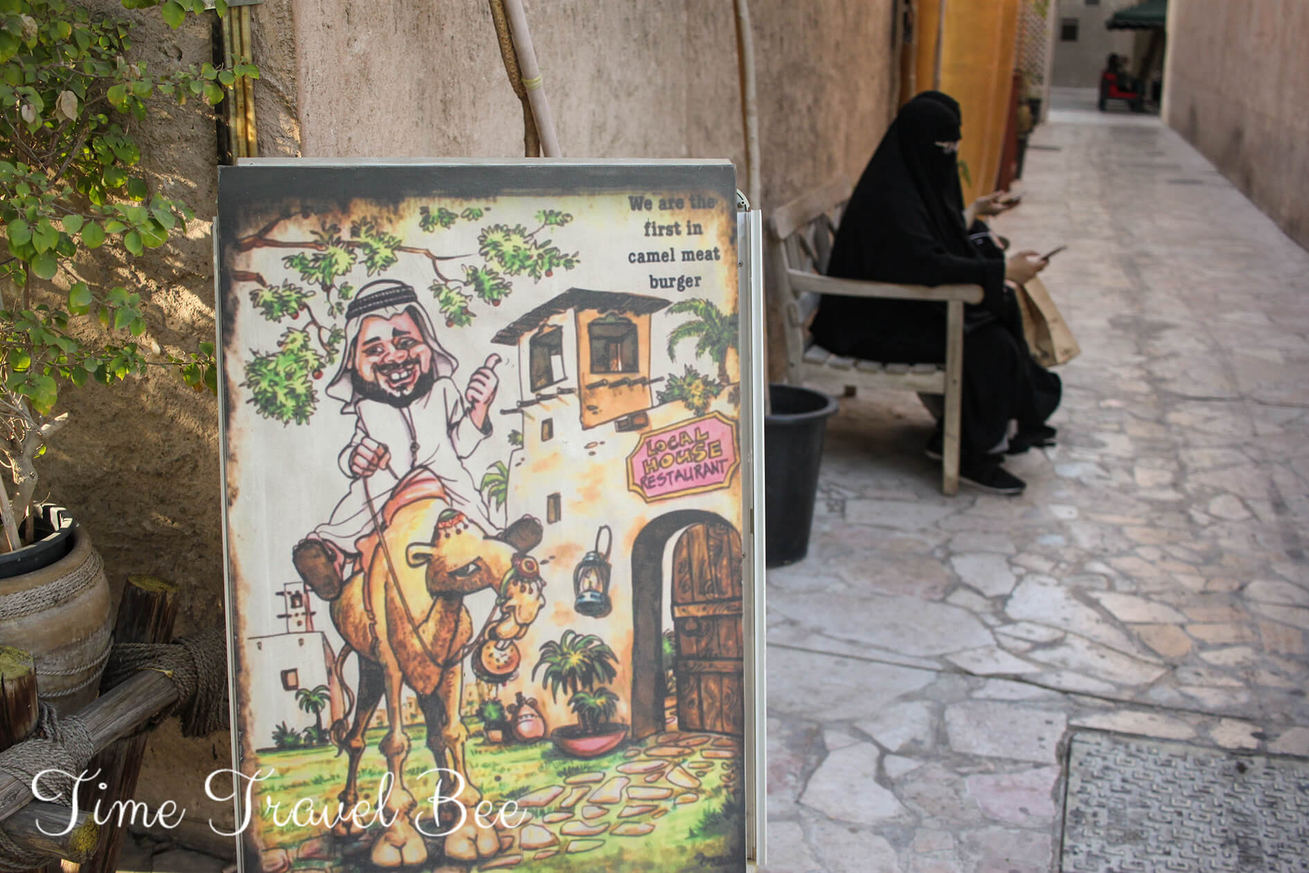 Responsible tourism guide to Dubai. Caricature on a man in traditional clothes and woman in abaya writting sms.c