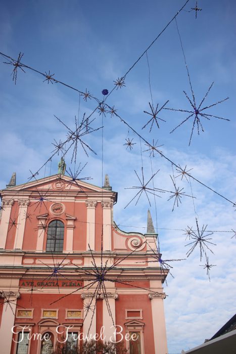 The church in Ljubljana, Slovenia with Christmas decorations. Stars decoration and blue sky. Weekned in Ljubljana.