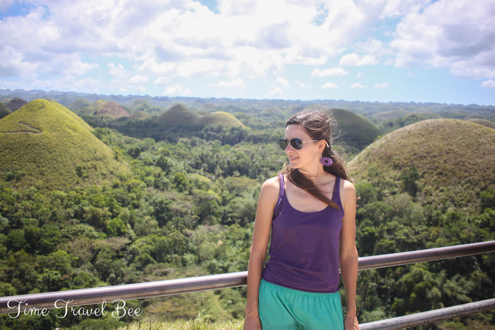 Girl posing on the Chocolate Hills view point in Bohol, Philippines.