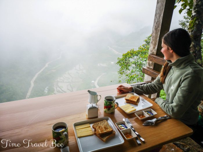 Breakfast with a view on World Heritage Rice Terraces. Girl eating breakfast with the view.