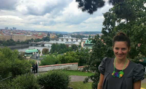 Prague view point with the best view in Prague. With this guide your will see Prague like a local. Girl in Prague standing on the best viewpoint. Postcard from Prague with Prague's bridges on the castle hill.